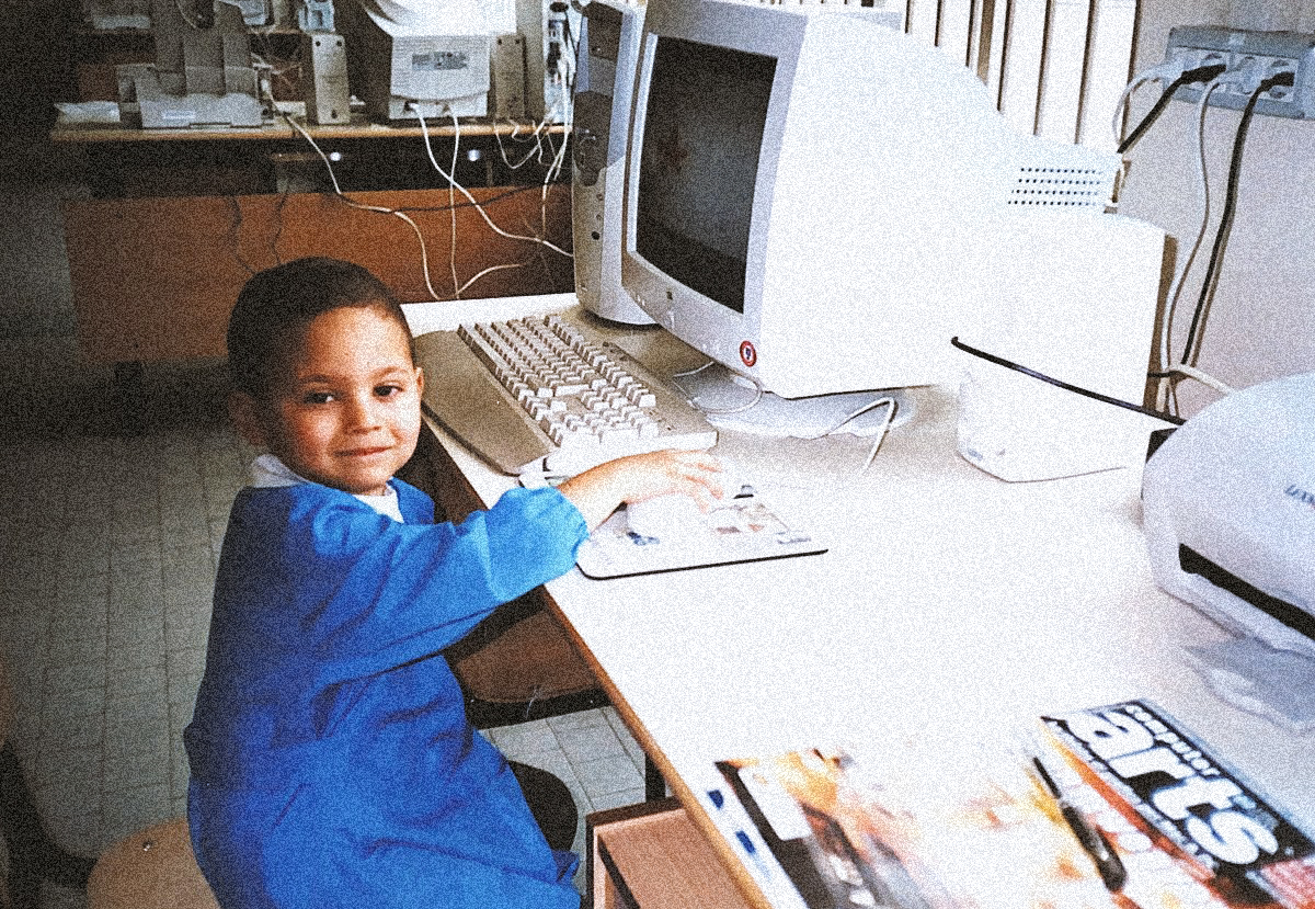 Dangiuz in first grade at the school computers with a copy of Computer Arts magazine